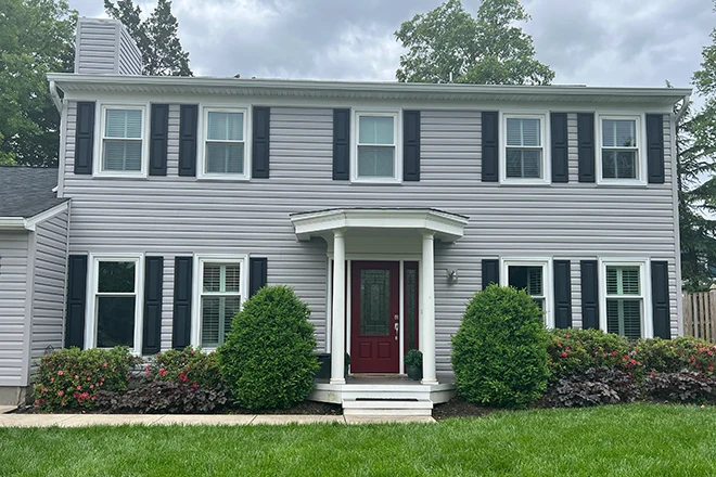 All new vinyl windows on the front of a house with white siding