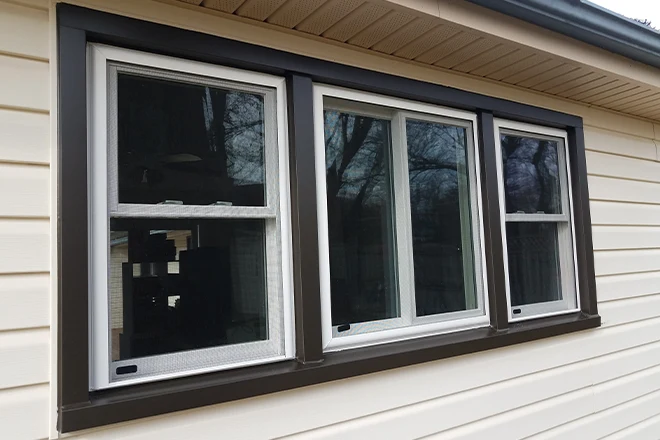 House with new windows that has a dark trim - Clifton Exteriors, LLC House with new windows that has a dark trim